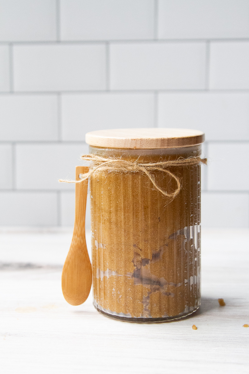 Brown sugar scrub in a cute glass jar with a wooden lid.