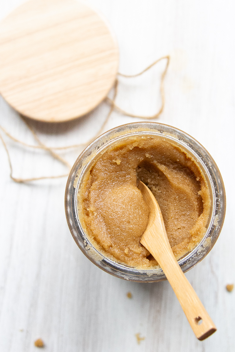 Brown sugar scrub in a cute glass jar and a little wooden spoon.