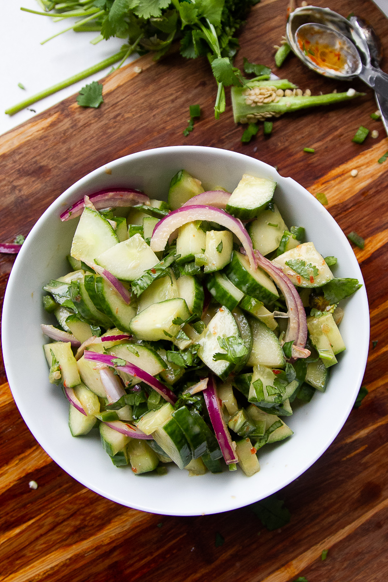 Asian cucumber salad finished in a white bowl.