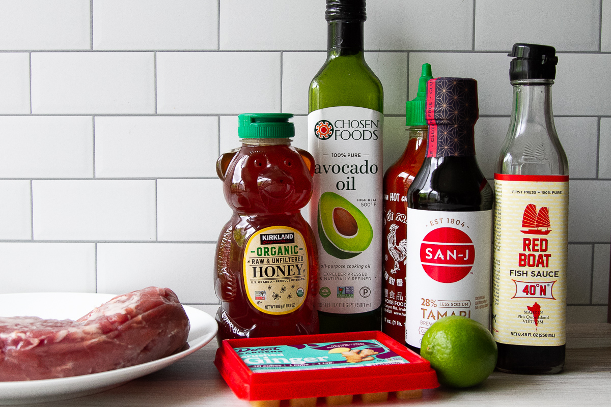 Ingredients for Asian Pork Tenderloin: pork tenderloin, honey, ginger, lime, avocado oil, sriracha, soy sauce, and fish sauce.