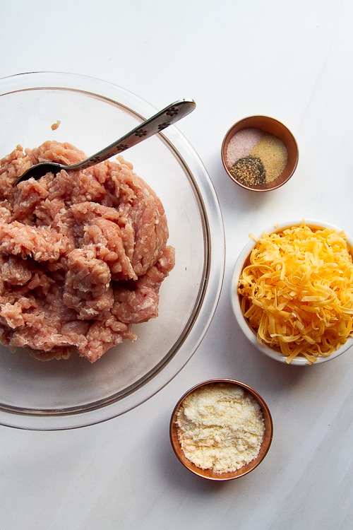 Ingredients for the chicken meatballs: ground chicken, shredded cheddar, parmesan cheese, granulated garlic, sea salt, and black pepper. 
