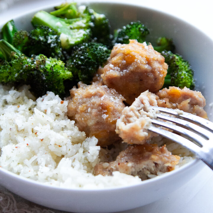 chicken meatballs in a bowl with broccoli and rice