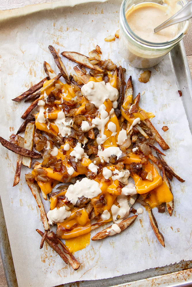 Overhead shot of the fries with a jar of burger sauce next to it.