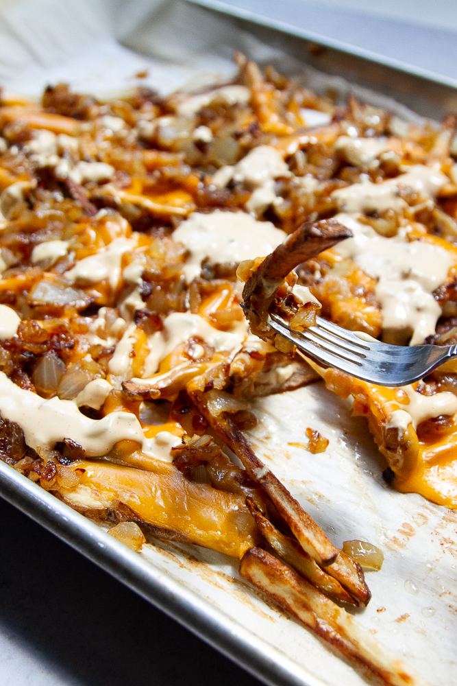 Homemade Animal Style fries on a sheet pan. 