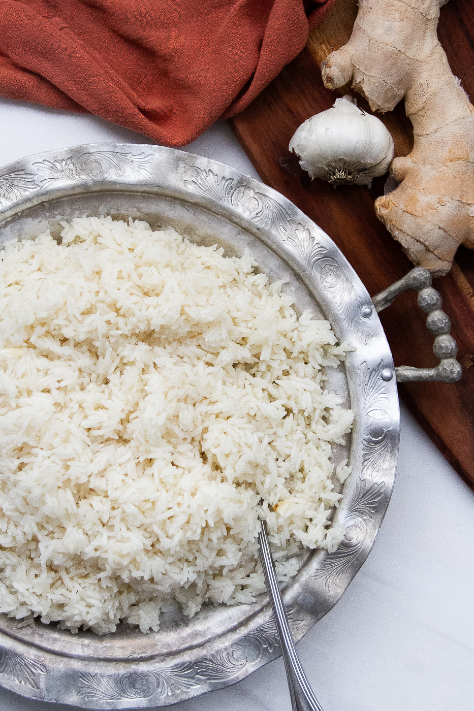 Garlic ginger rice in an antique silver serving dish.