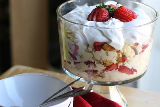 Finished strawberries trifle topped with whipped cream & strawberries.