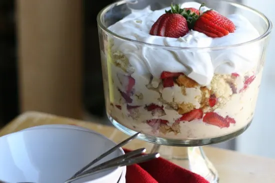Finished strawberries trifle topped with whipped cream & strawberries.