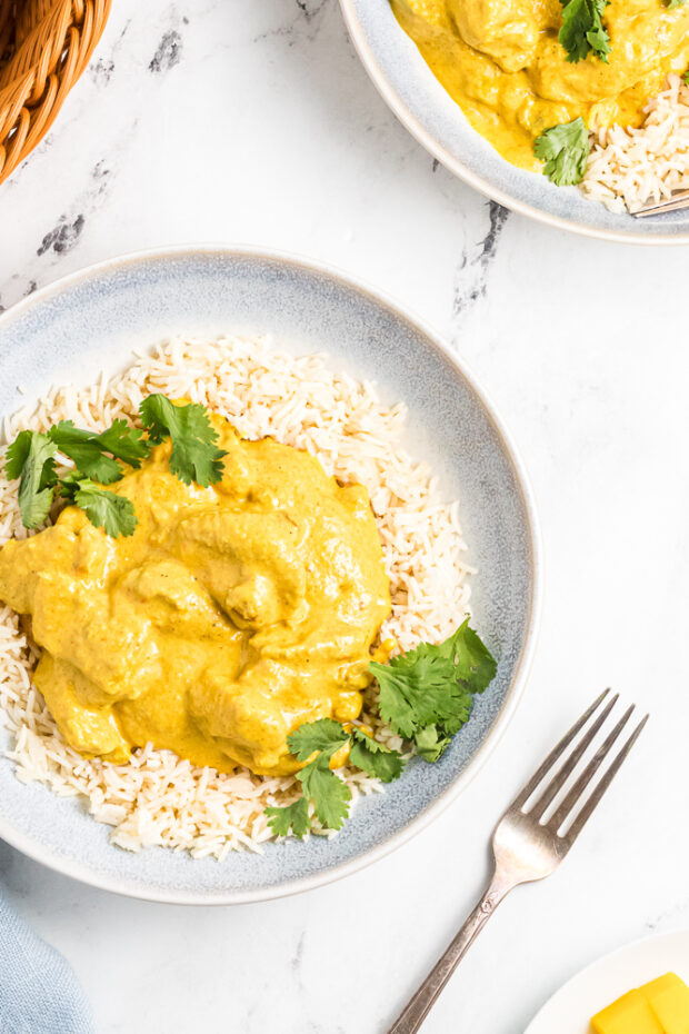 Delicious Mango Chicken Curry over steamed rice in two bowls ready to eat.