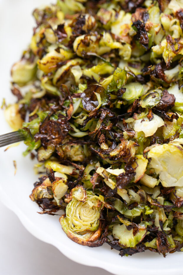 Crispy Roasted Shredded Brussels Sprouts in a serving bowl with caramelized edges.