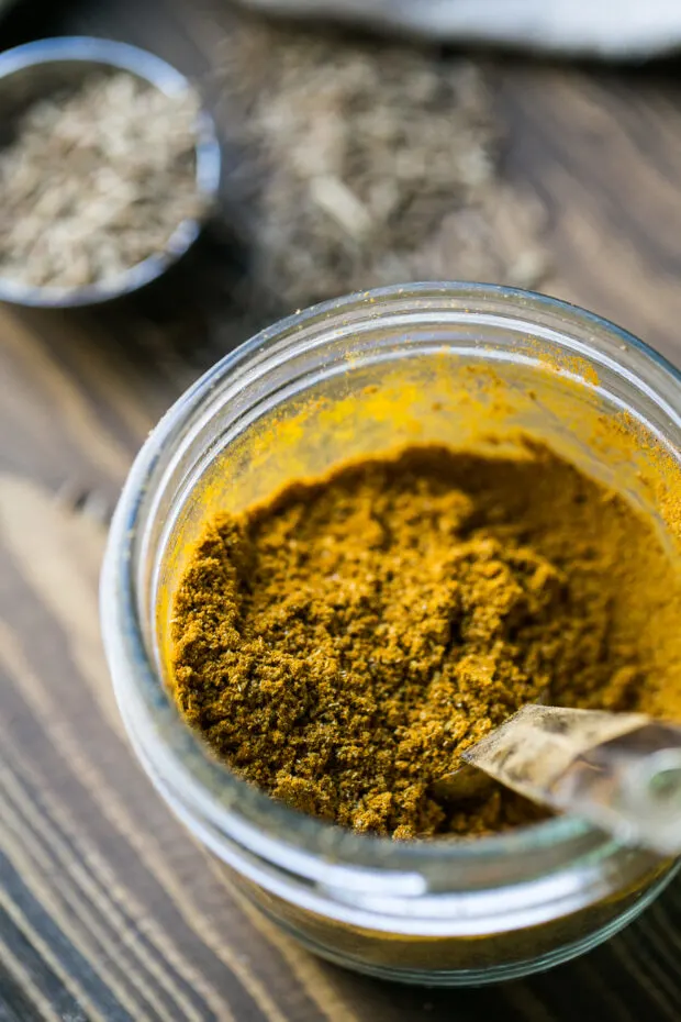 A glass jar with homemade curry powder