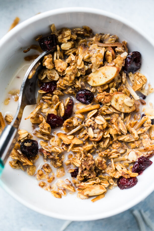 Homemade low sugar granola in a bowl with almond milk 