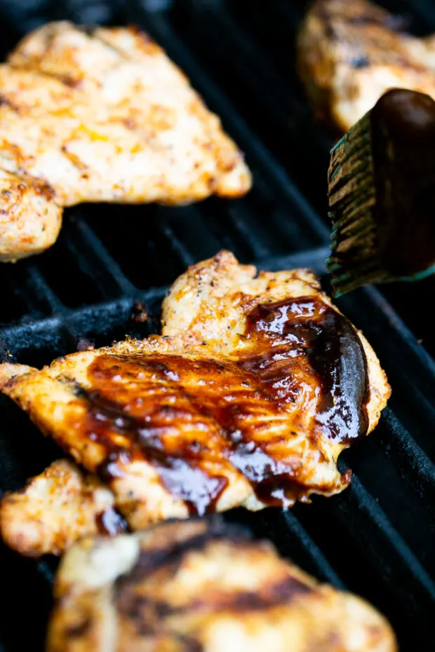 Brushing BBQ Sauce on the grilled chicken towards the end keeps the sauce from burning.