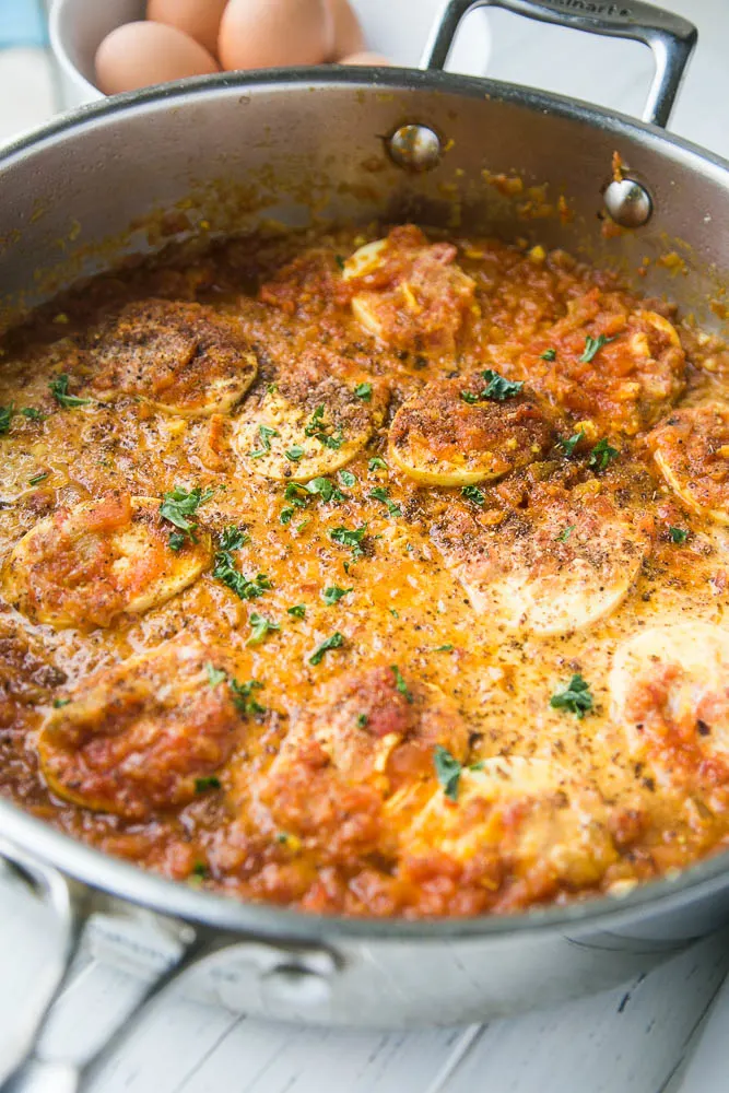 Egg curry is a great place for leftover hard-cooked eggs and makes a great, easy meatless meal! Indian-style Egg Curry in a skillet ready to be eaten.