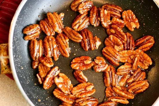 Make these 5-Minute Maple-Ginger Glazed Pecans and throw them on a salad or serve them as a quick little treat at a party! | pecan recipes | paleo recipes | salad toppings | - www.PerrysPlate.com