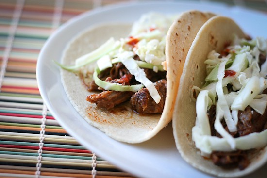 If you love that drippy, flavorful shredded beef in tacos from those hole-in-the-wall places, you HAVE to try this. It's easy to make a big batch of this shredded beef in your slow cooker! | perrysplate.com