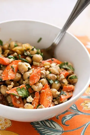 This is such a fun and unique take on a bean salad -- using cumin-roasted carrots and hearty mix-ins like feta and walnuts. | perrysplate.com This is such a fun and unique take on a bean salad -- using cumin-roasted carrots and hearty mix-ins like feta and walnuts. | perrysplate.com
