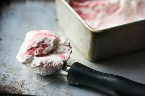 Have you ever roasted strawberries? It makes such a lovely swirl for this sweet and gingery ice cream that is naturally sweetened and can easily be made dairy free! | perrysplate.com
