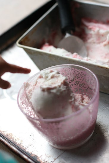 Have you ever roasted strawberries? It makes such a lovely swirl for this sweet and gingery ice cream that is naturally sweetened and can easily be made dairy free! | perrysplate.com