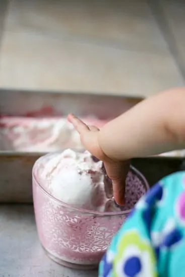 Have you ever roasted strawberries? It makes such a lovely swirl for this sweet and gingery ice cream that is naturally sweetened and can easily be made dairy free! | perrysplate.com