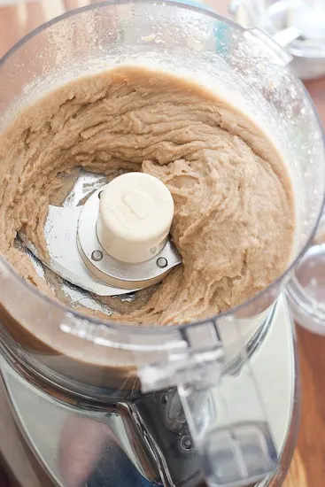 This homemade sugar scrub is a great DIY sugar scrub to use as a body exfoliator or a face scrub! You can also use salt or white sugar, too. View of food processor with blended sugar scrub.