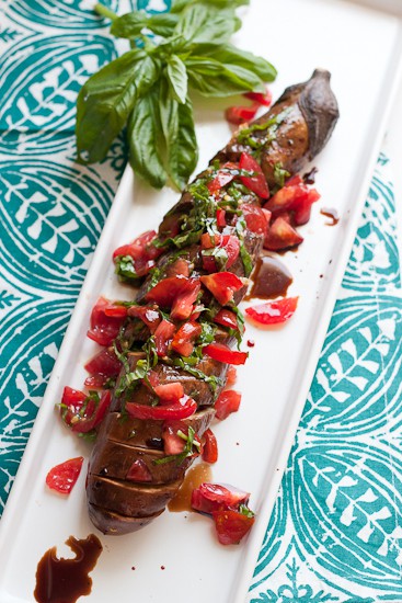 This is such a fun grilled vegetarian grilled dish! Garlic-studded eggplant turns silky soft when grilled for a long time and that slightly spicy tomato relish is the perfect topping! | perrysplate.com This is such a fun grilled vegetarian grilled dish! Garlic-studded eggplant turns silky soft when grilled for a long time and that slightly spicy tomato relish is the perfect topping! | perrysplate.com