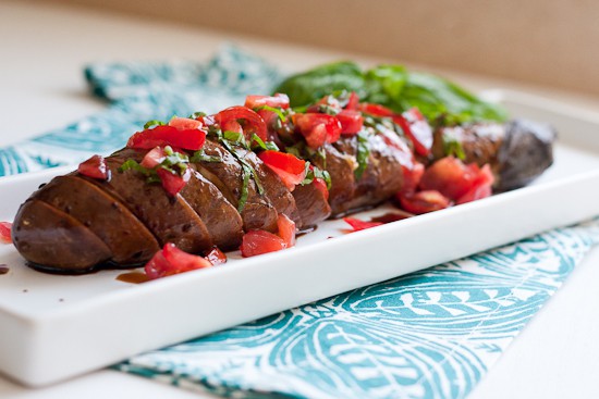 This is such a fun grilled vegetarian grilled dish! Garlic-studded eggplant turns silky soft when grilled for a long time and that slightly spicy tomato relish is the perfect topping! | perrysplate.com 