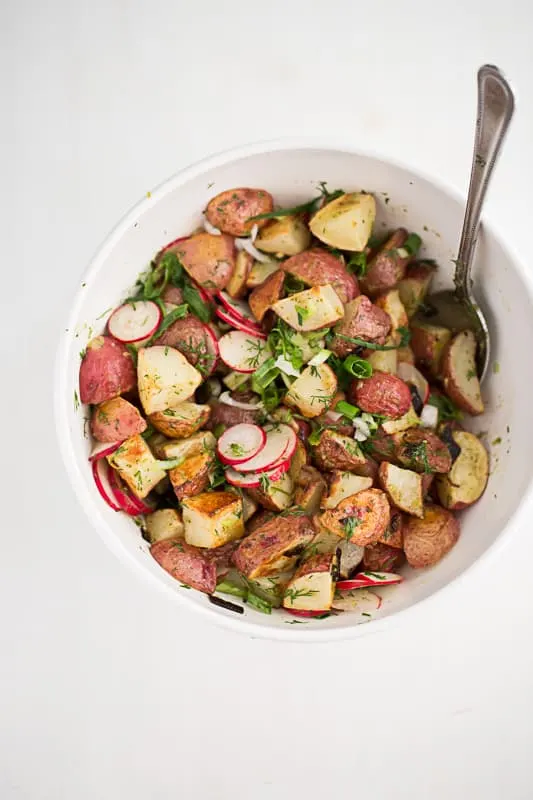 This is a fresh, mayo-free take on a potato salad. Tender roasted potatoes are tossed with a herby, mustardy vinaigrette. You'll never go back to regular potato salads. | perrysplate.com This is a fresh, mayo-free take on a potato salad. Tender roasted potatoes are tossed with a herby, mustardy vinaigrette. You'll never go back to regular potato salads. | perrysplate.com