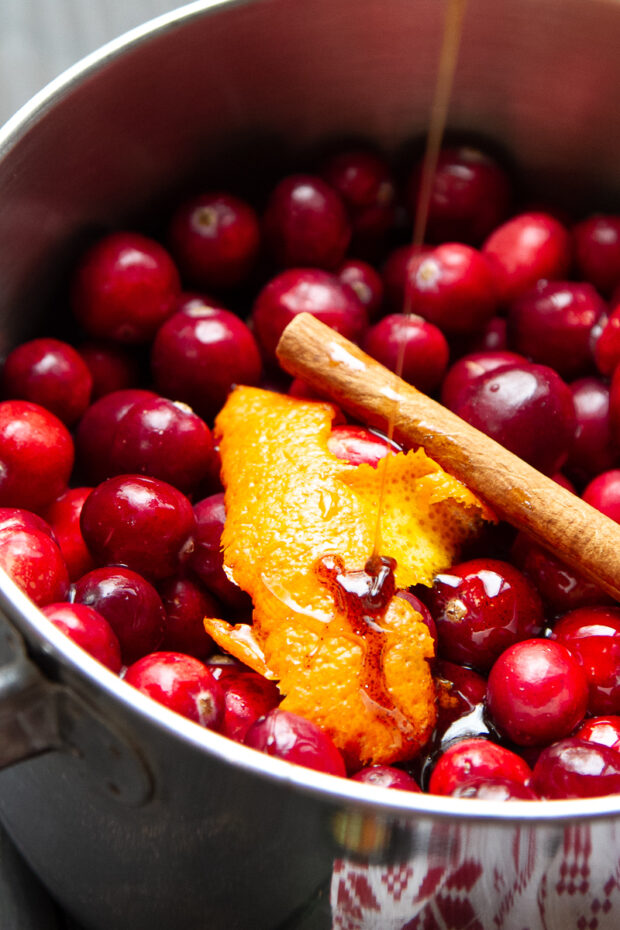 Adding vanilla bean paste to the saucepan.