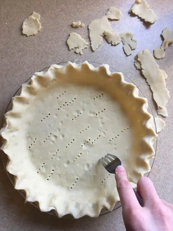 Perfect Gluten-Free Pie Crust -- Even better than most traditional pie crusts! | perrysplate.com | gluten-free recipes | gluten-free baking Trimmed and crimped pie crust dough with fork pricks in the bottom to keep it from bubbling while it's pre-baked.