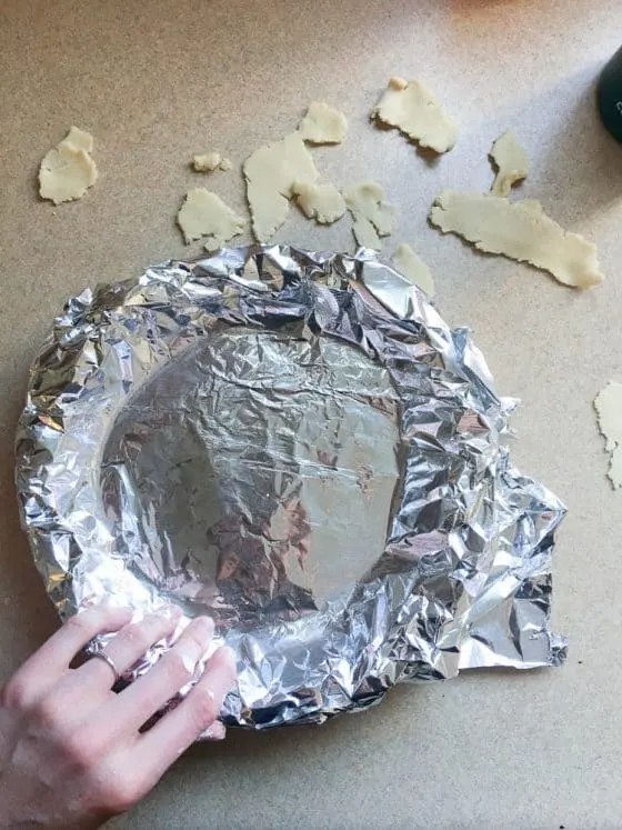 Pie crust dough covered with foil to prepare for baking. You can add pie weights here if you like. 