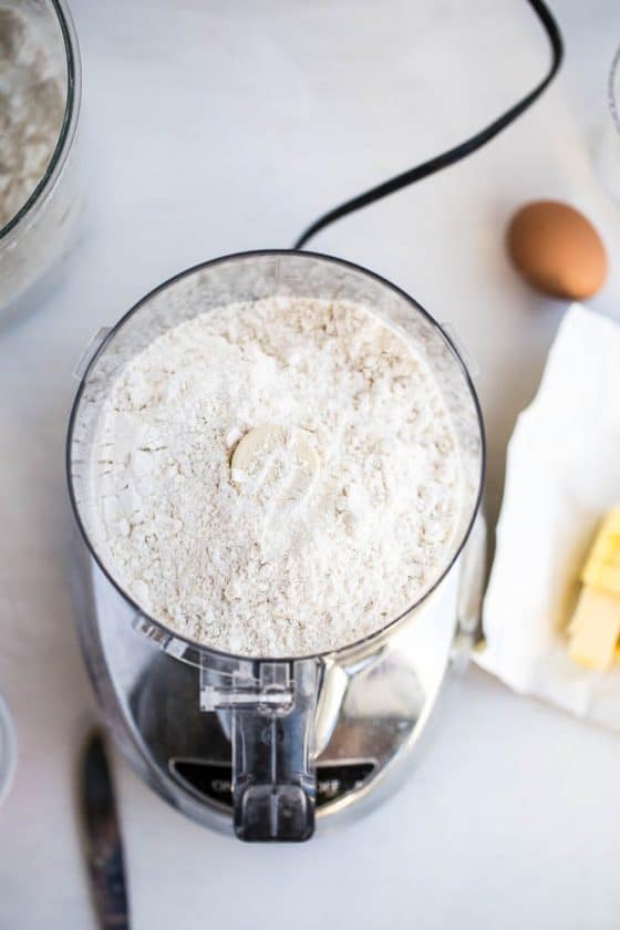 Perfect Gluten-Free Pie Crust -- Even better than most traditional pie crusts! | perrysplate.com | gluten-free recipes | gluten-free baking Food processor with gluten-free flour mixture ready to make pie crust dough.