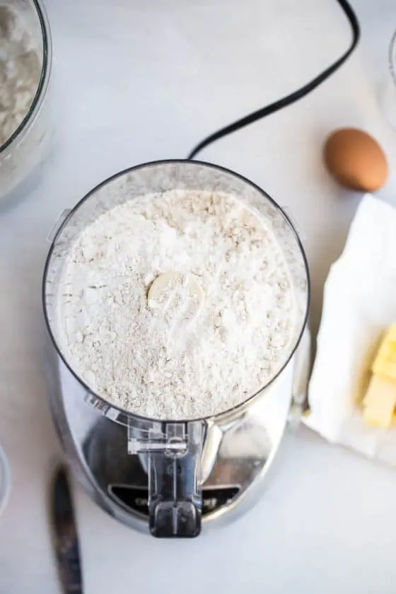 Perfect Gluten-Free Pie Crust -- Even better than most traditional pie crusts! | perrysplate.com | gluten-free recipes | gluten-free baking Food processor with gluten-free flour mixture ready to make pie crust dough.