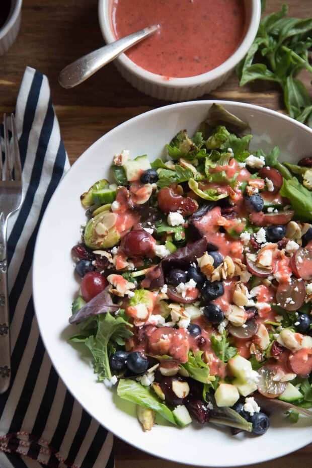 Toasted Brussels Sprout Salad with Strawberry Basil Vinaigrette -- a fruity, hearty salad with cheese, nuts, and a delicious dressing.