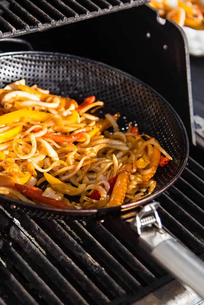 These are the best chicken fajitas you'll ever eat. Truly. And they make the best leftovers, too! The marinade is quick and paleo-friendly. View from the grill pan with caramelized onions and peppers.
