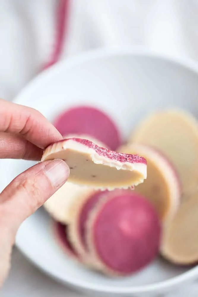 These keto friendly, sugar free fat bombs are the BEST little treat! The raspberry flavor is so strong and together they taste like a white chocolate raspberry truffle. Totally delicious. White Chocolate Raspberry Fat Bombs | The Everyday Ketogenic Kitchen | keto recipes | paleo recipes | dairy-free recipes | sugar free recipes | low carb recipes