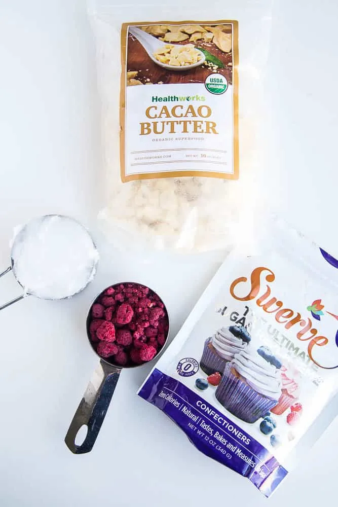 These keto friendly, sugar free fat bombs are the BEST little treat! The raspberry flavor is so strong and together they taste like a white chocolate raspberry truffle. Totally delicious. White Chocolate Raspberry Fat Bombs | The Everyday Ketogenic Kitchen | keto recipes | paleo recipes | dairy-free recipes | sugar free recipes | low carb recipes