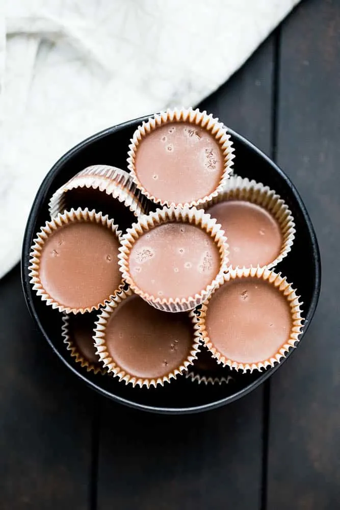 These little keto chocolate tahini fat bombs taste like a peanut butter cup without the nuts! They come together quickly and easily and will help keep your face out of the Reese's bag. | low-carb recipes | low carb high fat | perrysplate.com These little keto chocolate tahini fat bombs taste like a peanut butter cup without the nuts! They come together quickly and easily and will help keep your face out of the Reese's bag. | low-carb recipes | low carb high fat | perrysplate.com