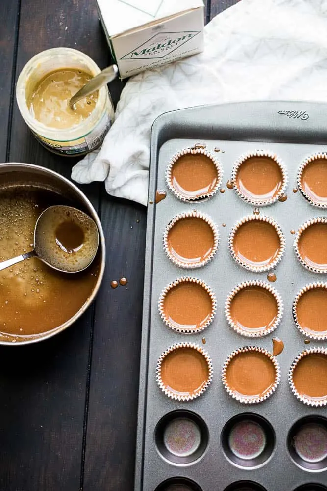 These little keto chocolate tahini fat bombs taste like a peanut butter cup without the nuts! They come together quickly and easily and will help keep your face out of the Reese's bag. | low-carb recipes | low carb high fat | perrysplate.com