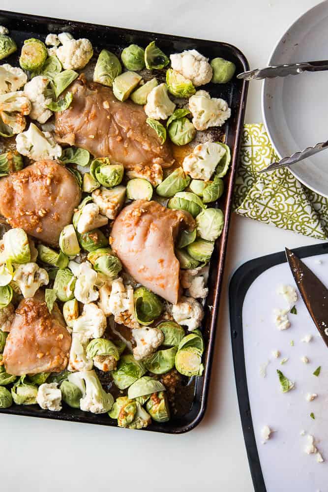 A sheet pan dinner is your best friend -- especially on the weeknights. This sheet pan BFF has chicken & veggies that cook up in a super easy Thai-inspired marinade. You can serve it as is (Paleo/Keto/Whole30 friendly!) or with some freshly steamed Jasmine rice. | PerrysPlate.com