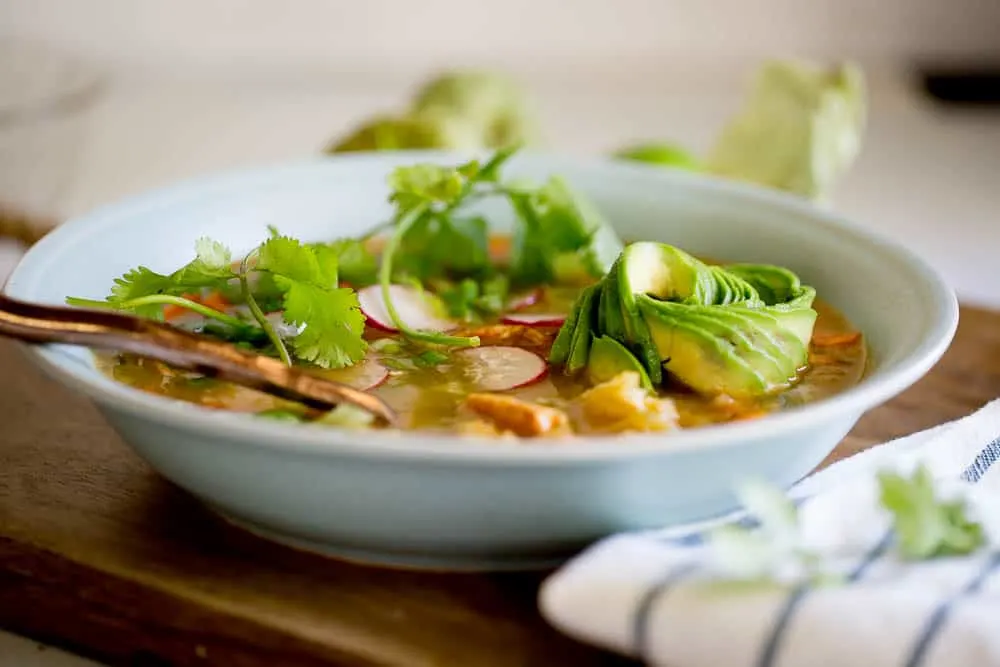 This Instant Pot Chicken Tomatillo Soup is perfect all year round! It's a perfect #paleo, #keto, or #Whole30recipe. Just don't skimp on the avocados! | perrysplate.com