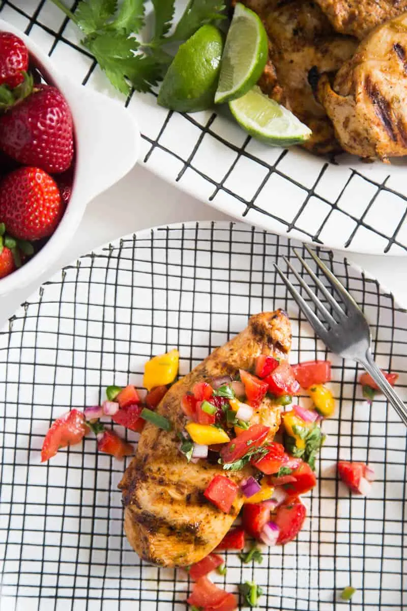 Chipotle-Lime Grilled Chicken with Strawberry Mango Salsa might be my favorite meal of the summer. It's easy to throw the chicken into a marinade ahead of time, and the kids all loved it! | perrysplate.com #grilledchicken #mangosalsa #summerrecipes