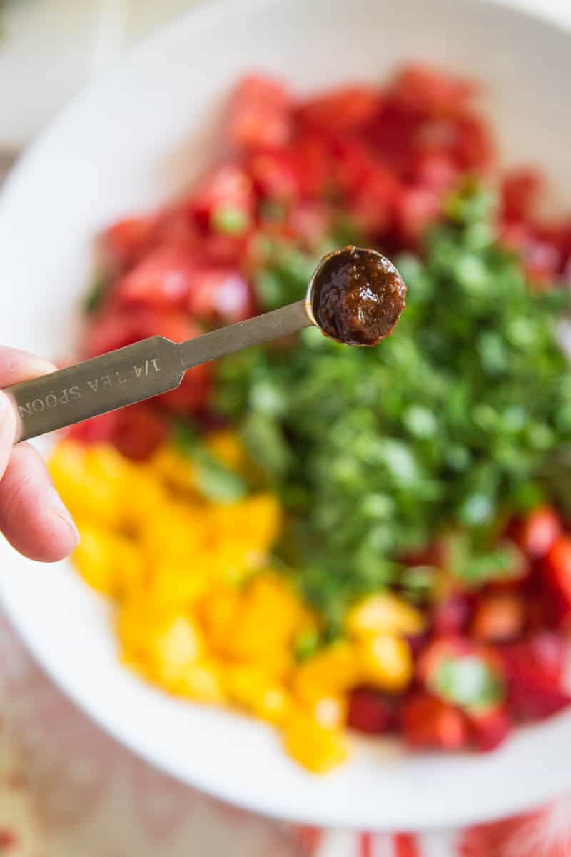 Chipotle-Lime Grilled Chicken with Strawberry Mango Salsa might be my favorite meal of the summer. It's easy to throw the chicken into a marinade ahead of time, and the kids all loved it! | perrysplate.com #grilledchicken #mangosalsa #summerrecipes