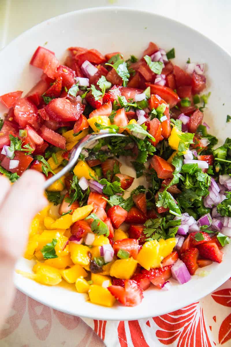 Chipotle-Lime Grilled Chicken with Strawberry Mango Salsa might be my favorite meal of the summer. It's easy to throw the chicken into a marinade ahead of time, and the kids all loved it! | perrysplate.com #grilledchicken #mangosalsa #summerrecipes