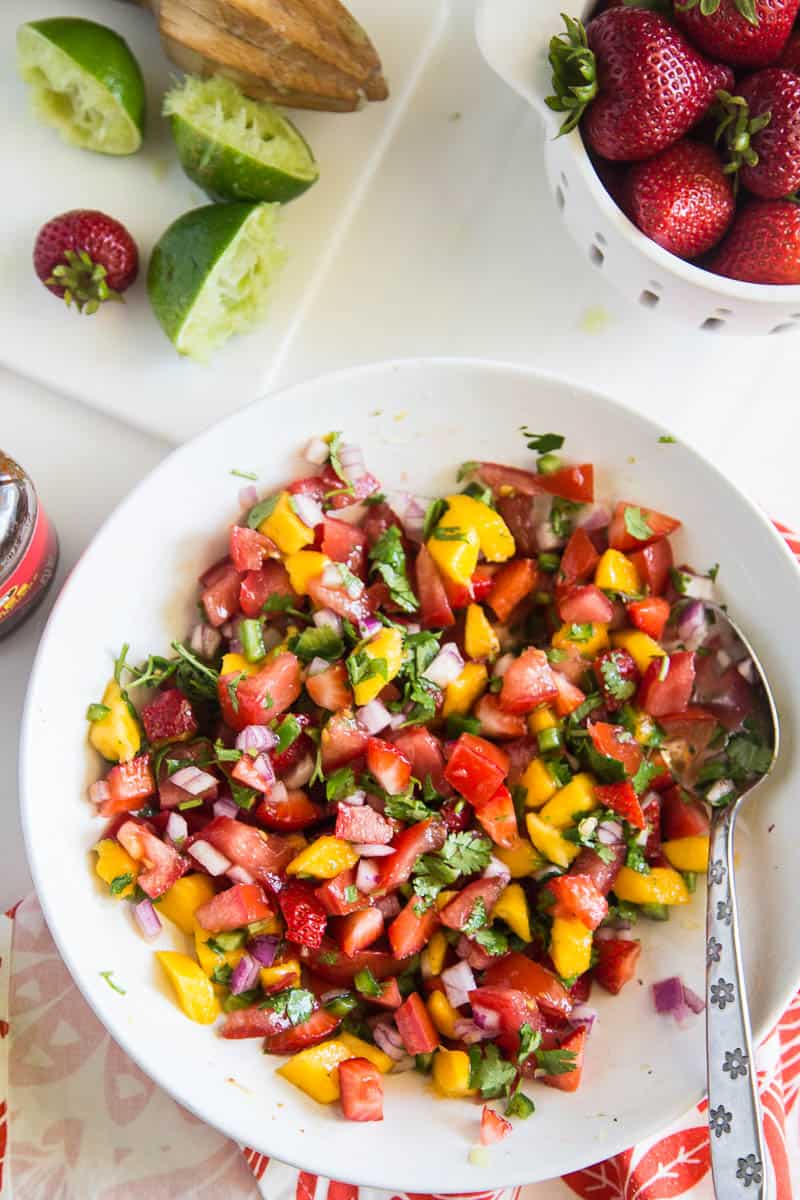 Chipotle-Lime Grilled Chicken with Strawberry Mango Salsa might be my favorite meal of the summer. It's easy to throw the chicken into a marinade ahead of time, and the kids all loved it! | perrysplate.com #grilledchicken #mangosalsa #summerrecipes
