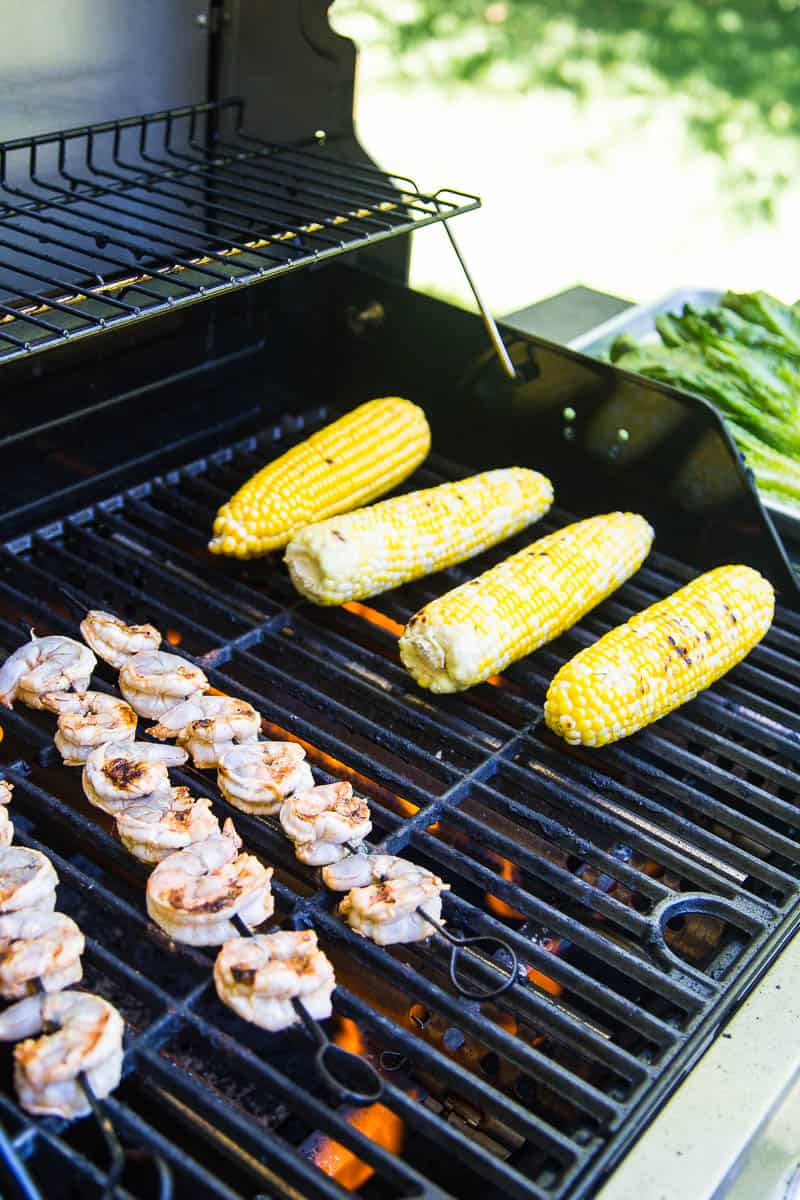 This is a fun, Southwest twist on a Caesar Salad with grilled romaine. (Yes, you can grill lettuce! It works!) The Cilantro-Lime Caesar Dressing is my favorite part. | perrysplate.com #caesarsalad #grilledshrimp #grilledcorn