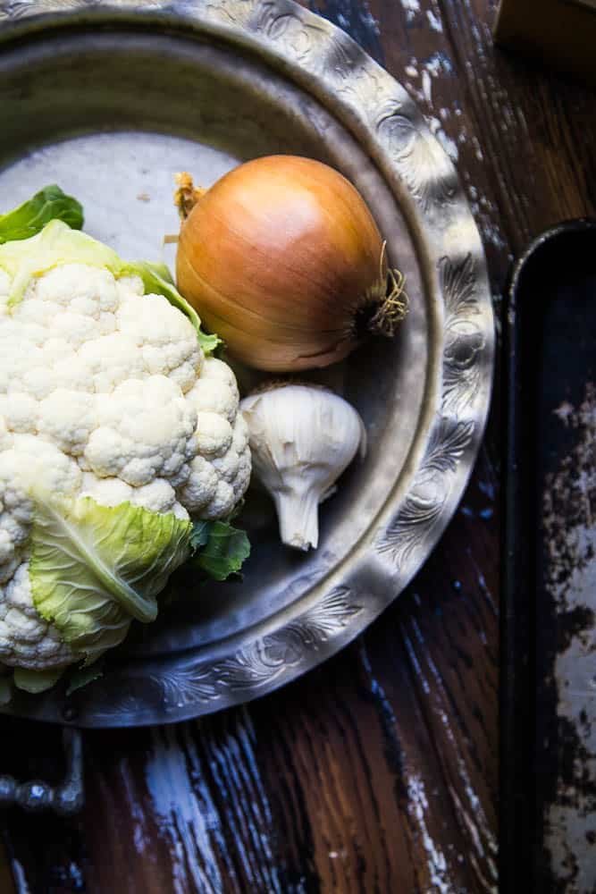 Cheesy Keto Roasted Cauliflower Soup only has a handful of ingredients and is a great recipe for meal prep or a busy weeknight! It's easily made Whole30 and paleo friendly, too! | perrysplate.com #ketorecipes #ketosoup #lowcarbrecipes