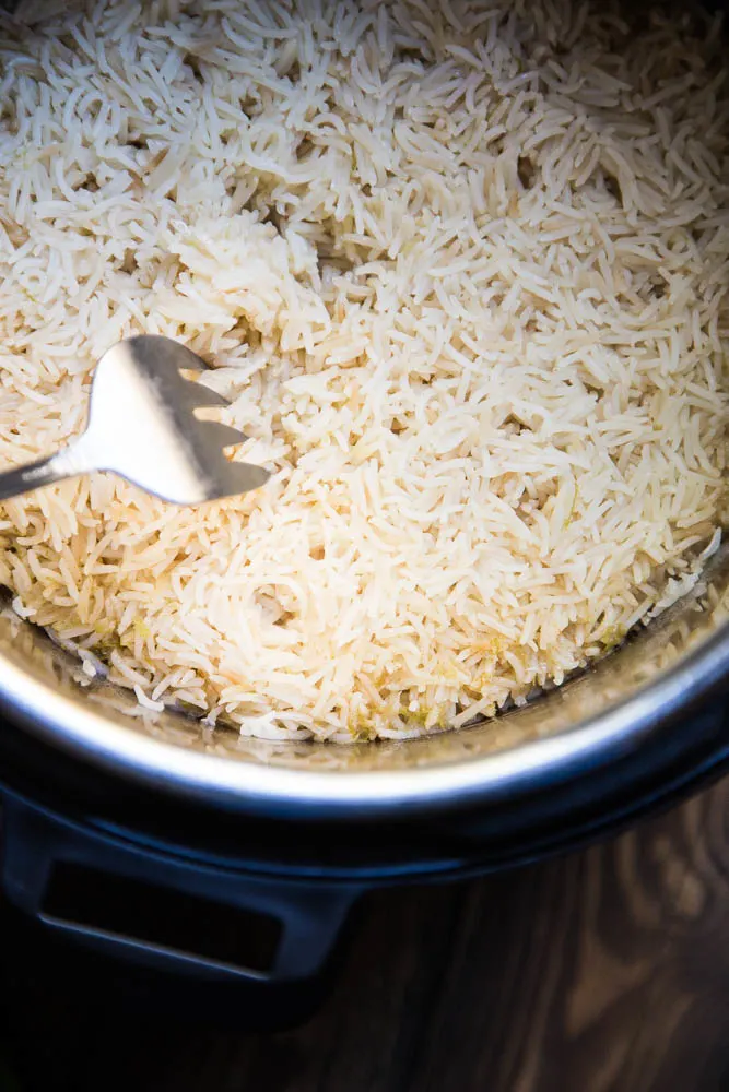 Fluffing Instant Pot Cilantro Lime Rice when the Instant Pot finishes | PerrysPlate.com #instantpotrecipes Fluffing Instant Pot Cilantro Lime Rice when the Instant Pot finishes | PerrysPlate.com #instantpotrecipes