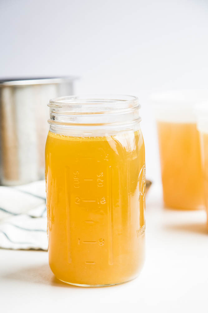 Make homemade chicken bone broth in under 3 hours with your Instant Pot! No more simmering a pot on the stove for an entire day. | perrysplate.com #instantpot #instantpotrecipes #bonebroth