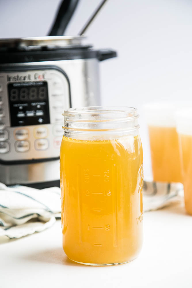 Make homemade chicken bone broth in under 3 hours with your Instant Pot! No more simmering a pot on the stove for an entire day. | perrysplate.com #instantpot #instantpotrecipes #bonebroth