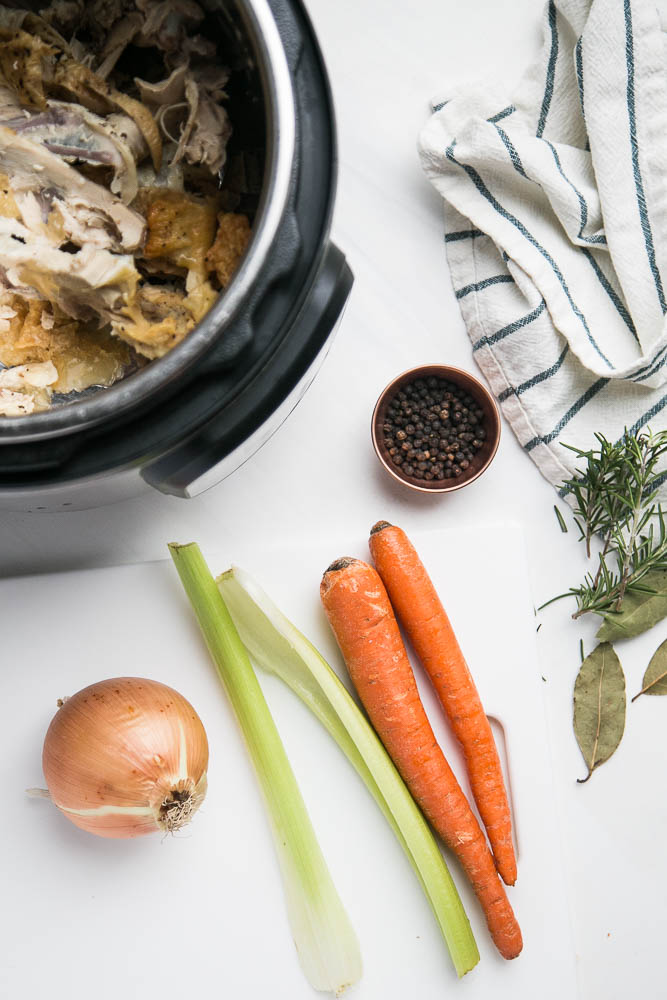 Make homemade chicken bone broth in under 3 hours with your Instant Pot! No more simmering a pot on the stove for an entire day. | perrysplate.com #instantpot #instantpotrecipes #bonebroth